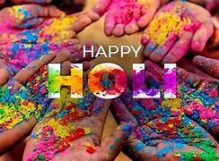 Small group celebrating Holi 2026 with colors and smiles